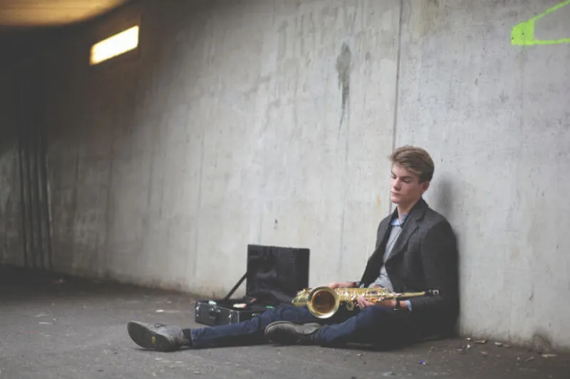 Man sitting down with his passion, the saxophone